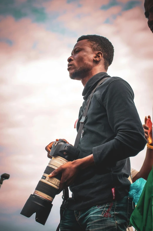 a man standing next to a woman holding a camera, by Matija Jama, pexels contest winner, black arts movement, protest, giving a speech, skies, full body potrait holding bottle
