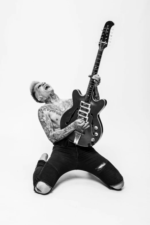 a black and white photo of a man with a guitar, an album cover, inspired by Cam Sykes, tattooed pinup, mateus 9 5, arms stretched out, sittin