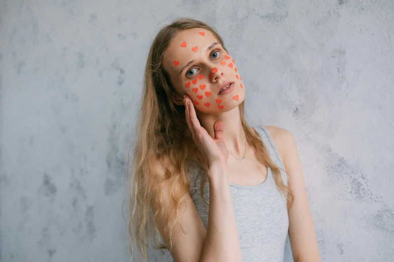 a woman with polka dots on her face, by Julia Pishtar, trending on pexels, hearts, dry skin, full body picture, pustules