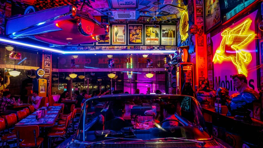 a car that is sitting in the middle of a room, by Meredith Dillman, pexels contest winner, maximalism, neon standup bar, diner scene, like a scene from blade runner, a colorful