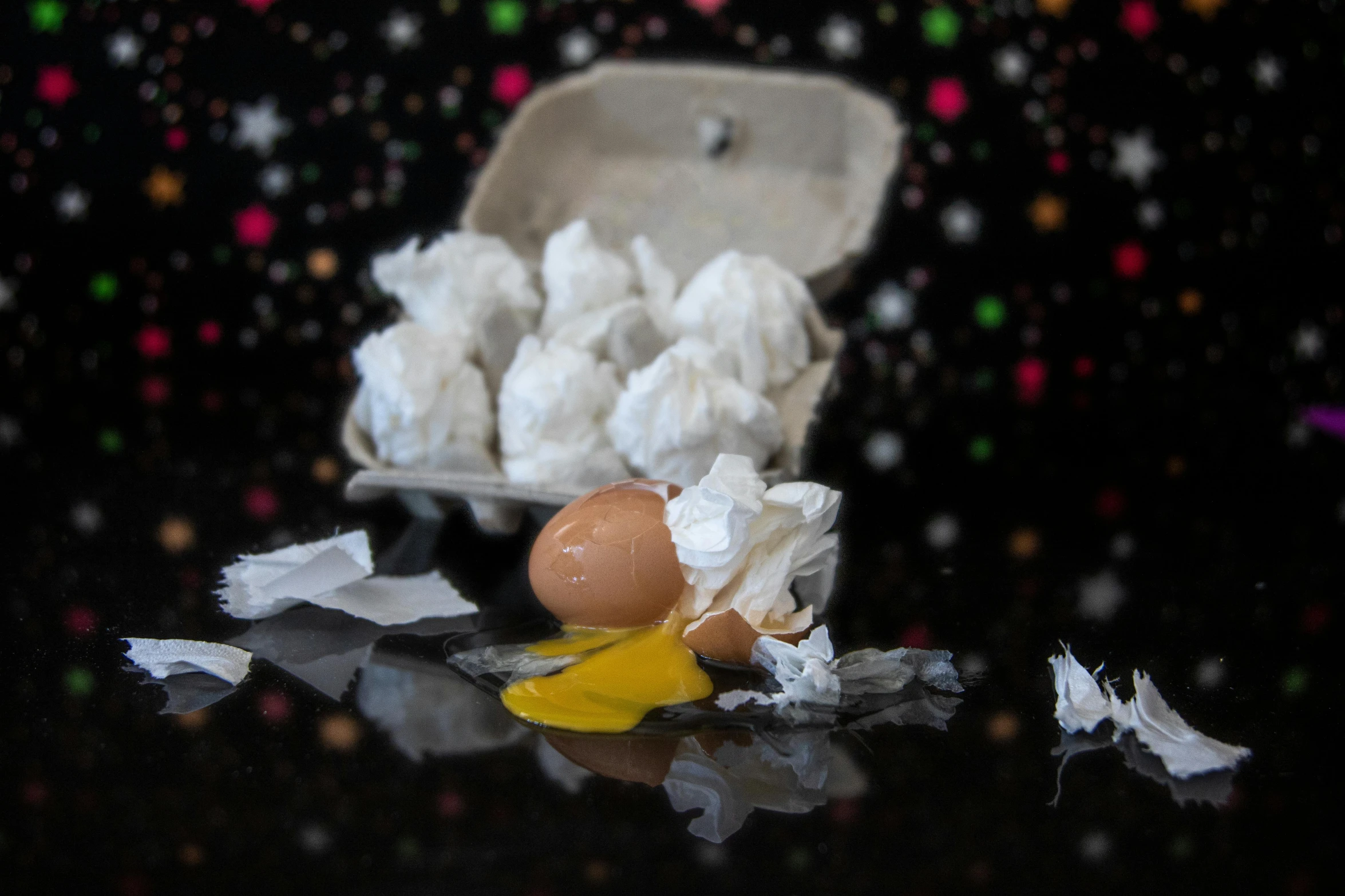 a broken egg sitting on top of a table, a still life, by Lee Loughridge, unsplash, happening, james webb telescope photo, gum tissue, collapsing stars, product shot