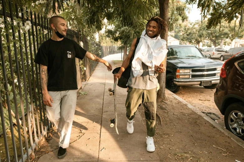 two men walking down a sidewalk holding hands, an album cover, unsplash, renaissance, lil uzi vert, looking happy, los angeles, bowater charlie and brom gerald