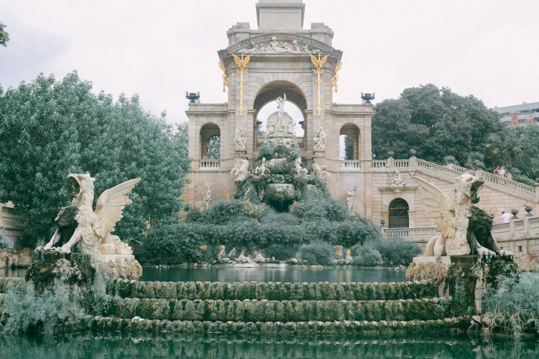 a fountain with statues and a clock tower in the background, inspired by Tomàs Barceló, pexels contest winner, baroque, moody : : wes anderson, 2 5 6 x 2 5 6 pixels, a park, giant majestic archways