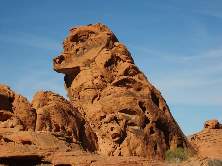 a large rock formation in the middle of a desert, a statue, by Linda Sutton, pexels contest winner, dog head, las vegas, square masculine jaw, red sandstone natural sculptures