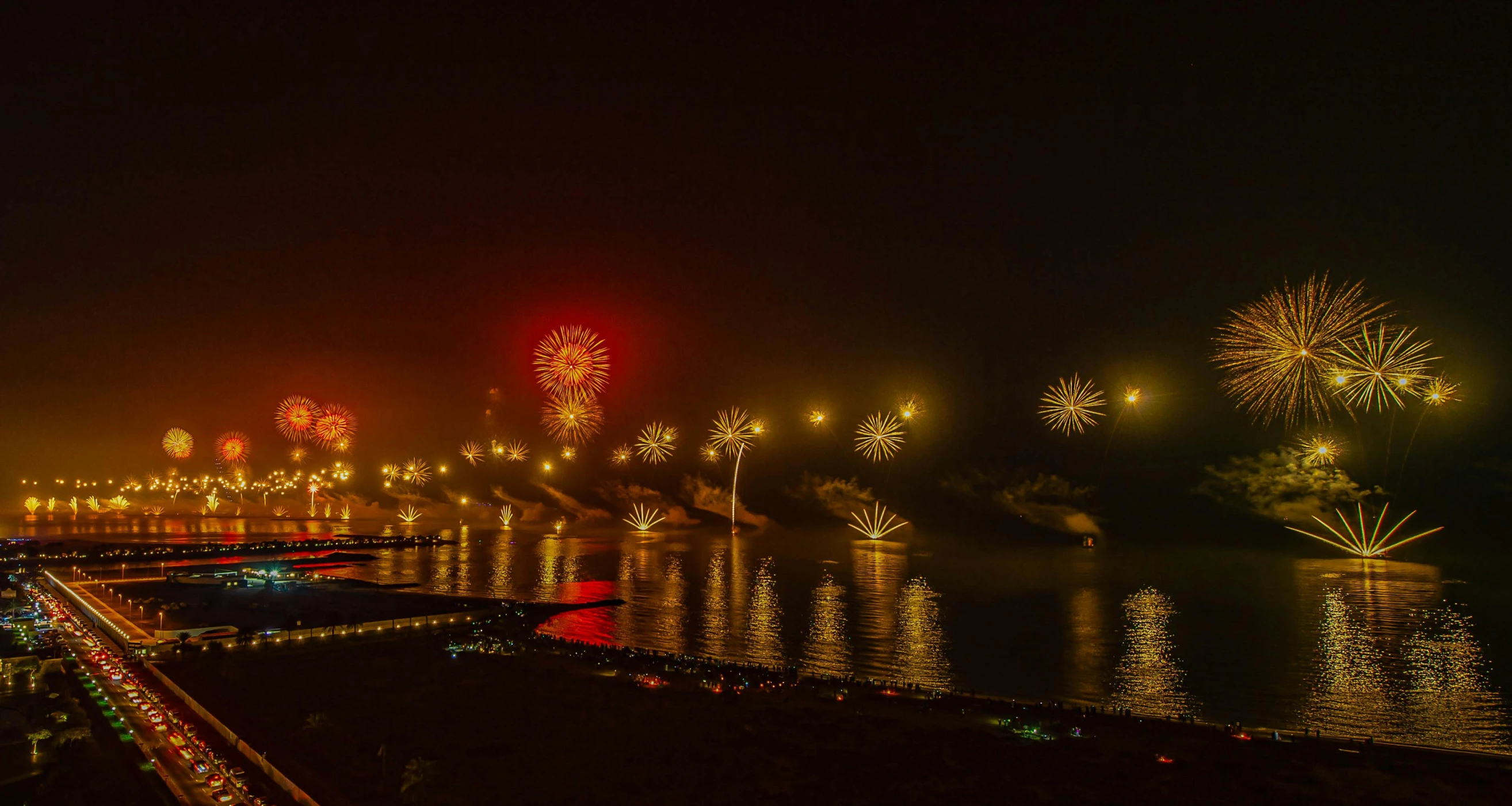 fireworks over a body of water with a bridge in the background, by Daniel Lieske, pexels contest winner, foggy photo 8 k, india, thumbnail, numerous fires