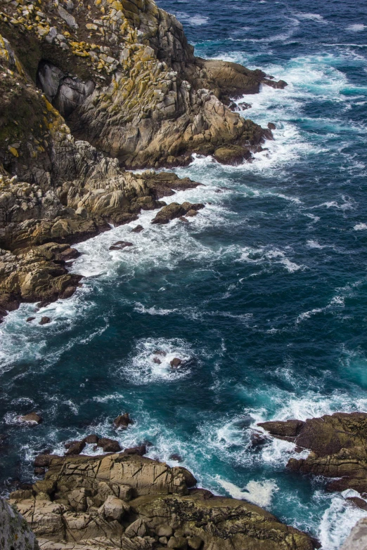 a large body of water next to a rocky shore, pexels contest winner, process art, wellington, offshore winds, close up shot from the top, today\'s featured photograph 4k