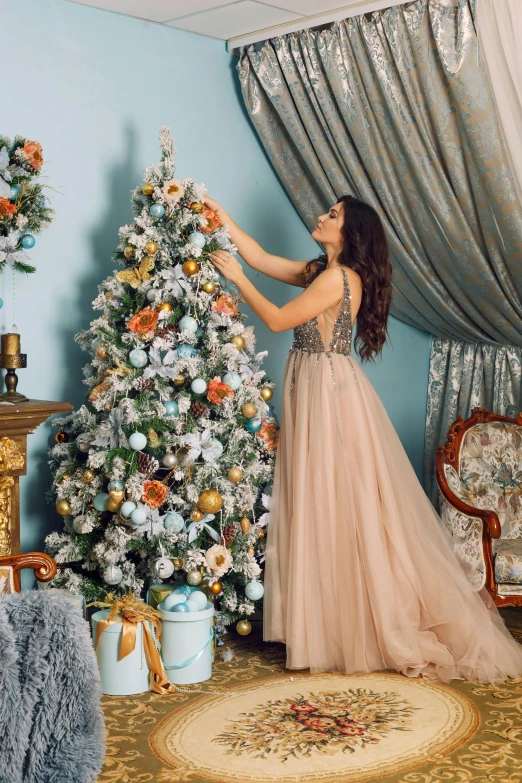 a woman standing in front of a christmas tree, shutterstock, baroque, decorated with flowers, style of julia razumova, square, in romantic style