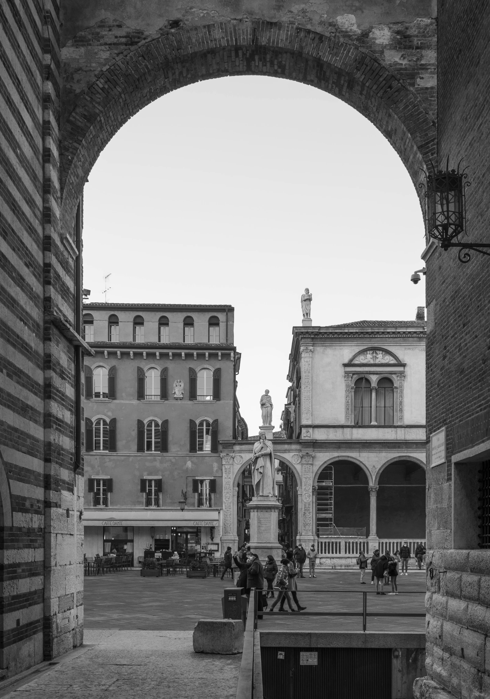 a black and white photo of a street, a black and white photo, by Giuseppe Camuncoli, archs, square, preserved historical, u