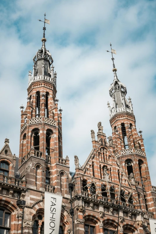 a tall brick building with a clock tower, by Jan Tengnagel, pexels contest winner, baroque, majestic spires, black and auburn colour pallet, flemish baroque, two horns