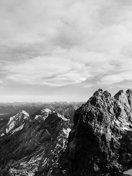 a black and white photo of a person standing on top of a mountain, by Matthias Weischer, asymmetrical spires, bird\'s eye view, fine art print, jovana rikalo