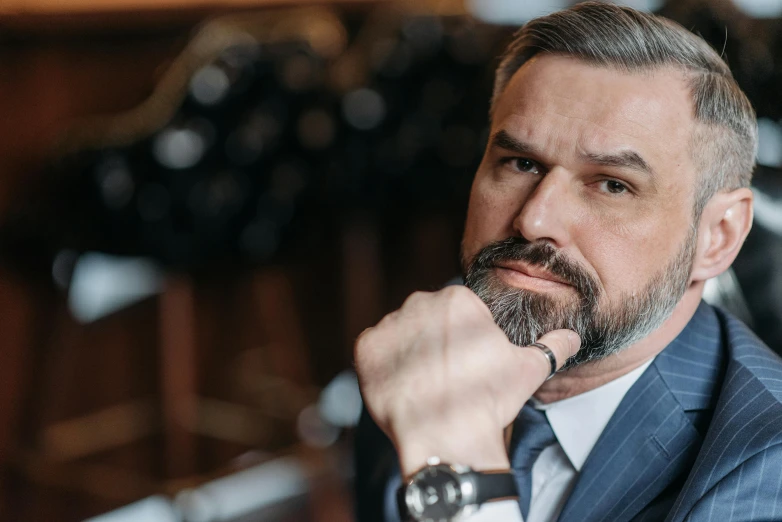 a close up of a man in a suit and tie, by Adam Marczyński, pexels contest winner, hurufiyya, some grey hair in beard, wearing a watch, 40 years old women, thumbnail