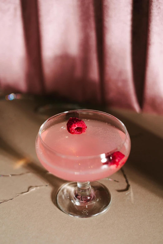 a pink cocktail sitting on top of a table, a portrait, inspired by Carlo Martini, unsplash, renaissance, raspberry, tufted softly, ecstatic, close together