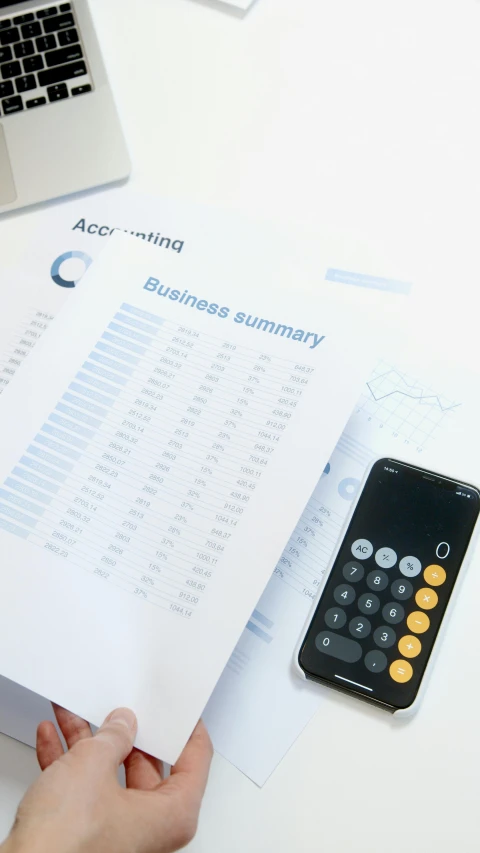 a person sitting at a desk with a calculator and a laptop, a digital rendering, pexels, papers on table, commercial banner, ap, high quality photo