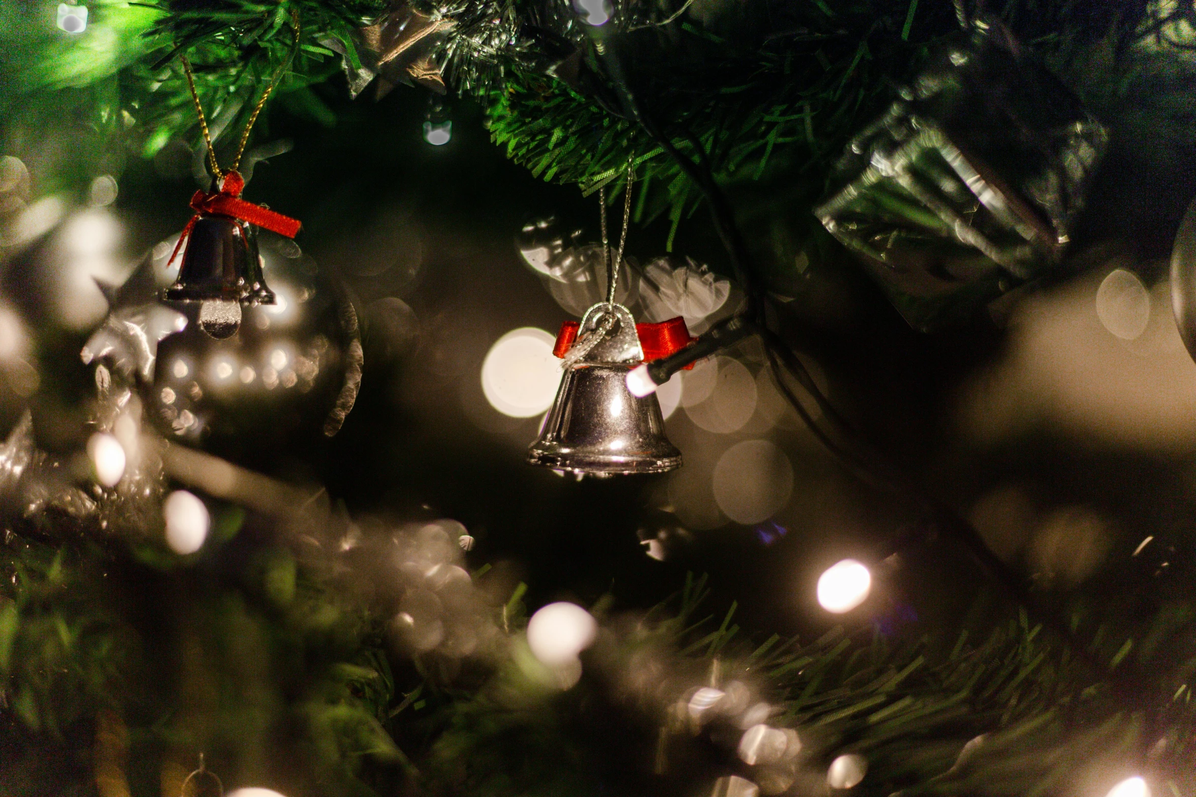 a close up of ornaments on a christmas tree, by Julia Pishtar, pexels, happening, bells, glowing with silver light, 15081959 21121991 01012000 4k, thumbnail