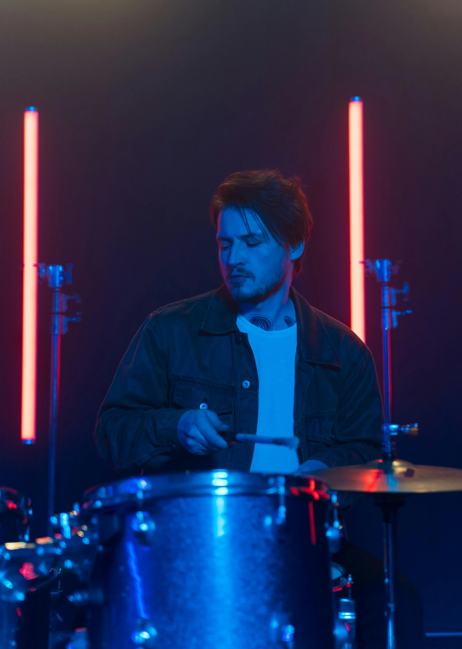 a man that is sitting in front of a drum, cinematic neon uplighting, tom burke, profile image, ( ( theatrical ) )