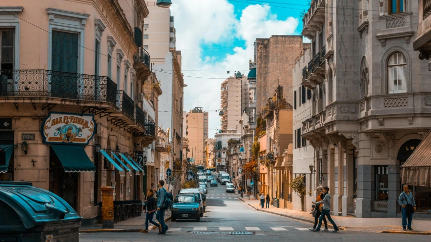 a group of people walking down a street next to tall buildings, by Matteo Pérez, pexels contest winner, neoclassicism, buenos aires, old town, super wide view of a cityscape, brown