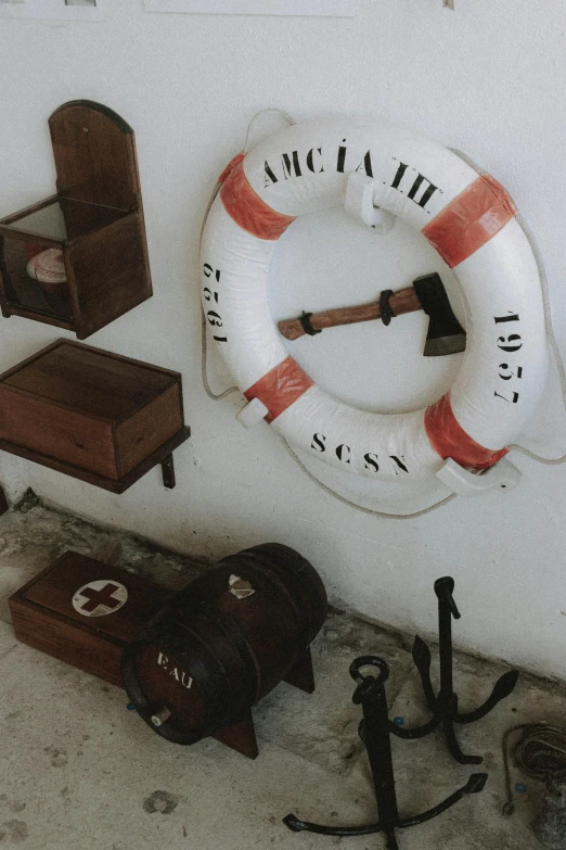 a white wall with a life preserver on it, visual art, crafts and souvenirs, historical footage, momento mori, tools