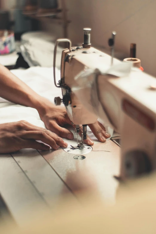 a woman is working on a sewing machine, a silk screen, by Byron Galvez, trending on unsplash, clothes made out of veins, thumbnail, surgery, cardboard