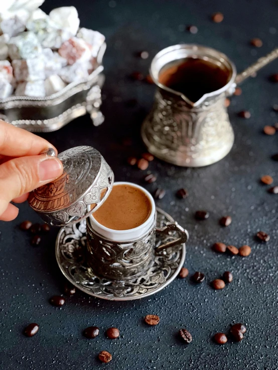 a close up of a person pouring a cup of coffee, dau-al-set, silver ornaments, instagram story, turkey, youtube thumbnail