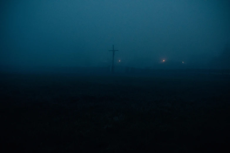 a foggy field with a telephone pole in the distance, an album cover, inspired by Elsa Bleda, exorcist, neon cross, dark blue atmosphere, dark photo