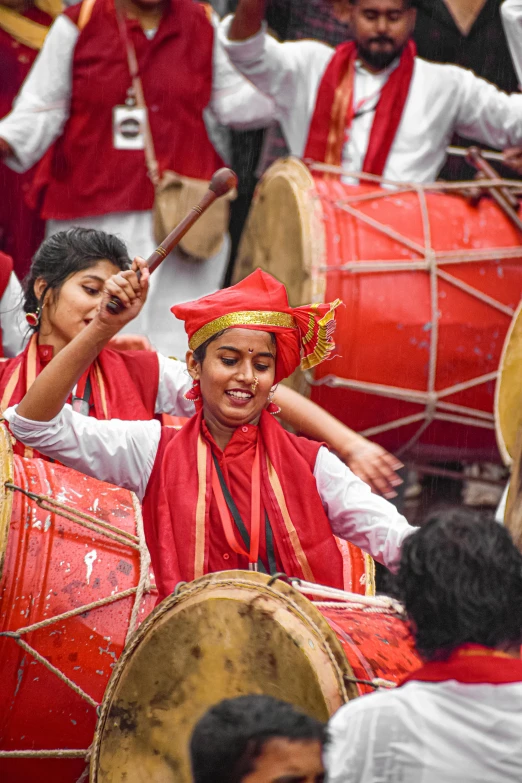 a group of people that are playing drums, bengal school of art, carnival, red adornements, uncropped, square