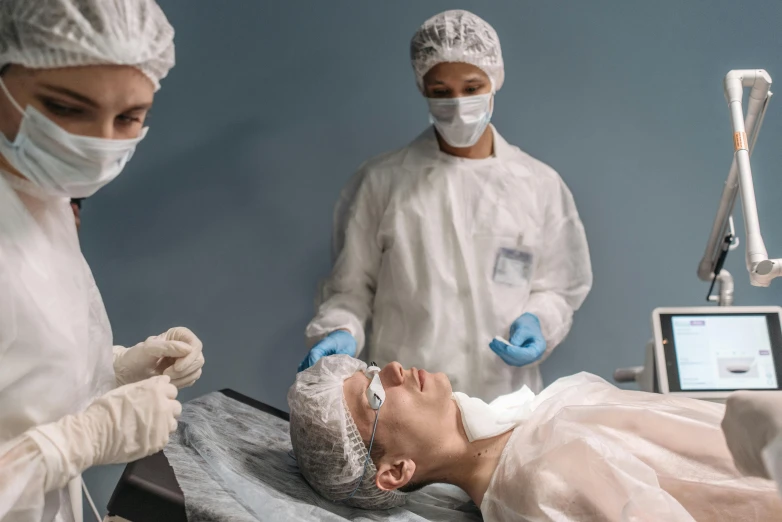 a group of doctors working on a patient, pexels contest winner, hyperrealism, square facial structure, sterile minimalistic room, 2717433015, fan favorite