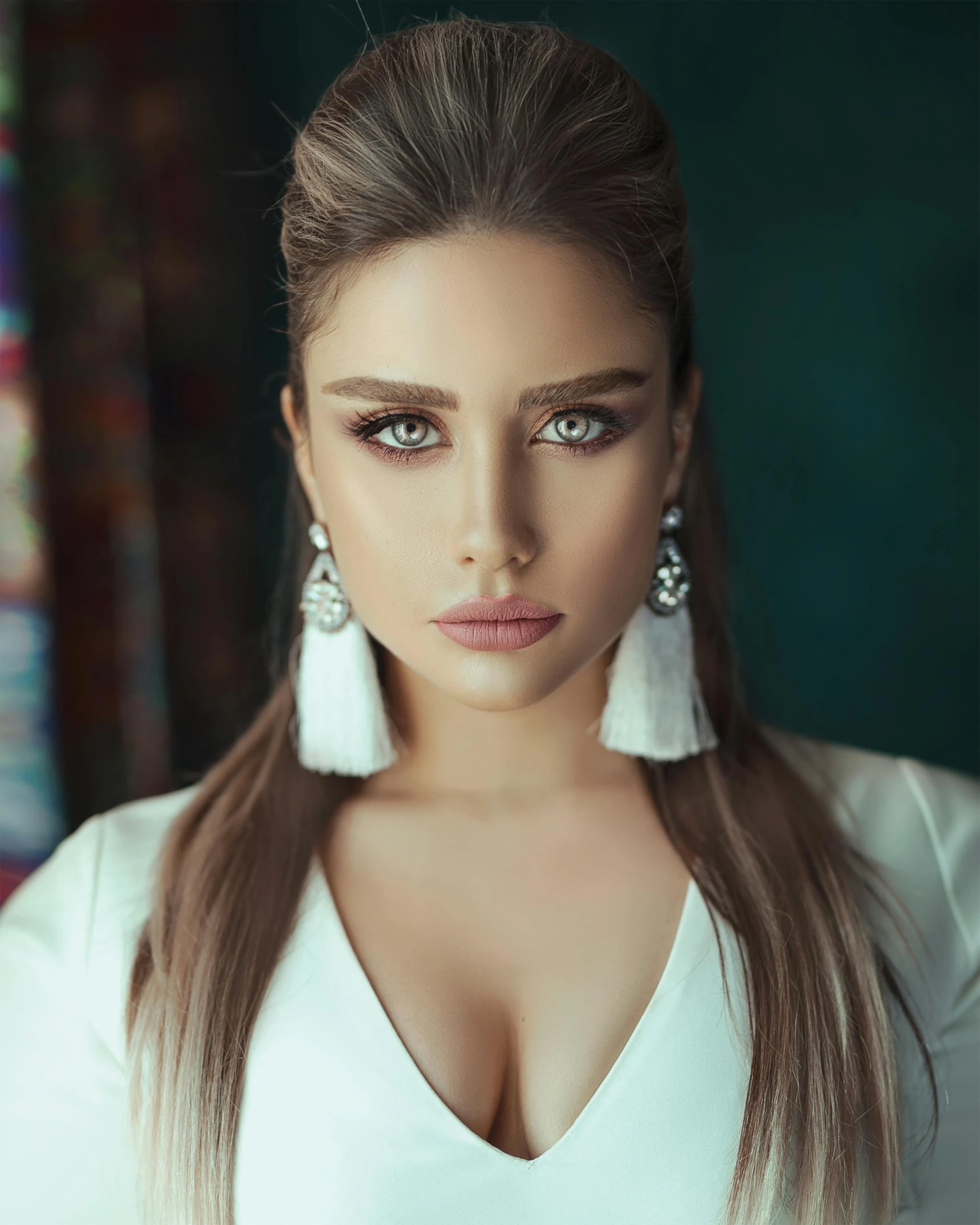 a woman in a white top posing for a picture, a colorized photo, by Dimitre Manassiev Mehandjiysky, trending on instagram, hurufiyya, huge earrings and queer make up, miss universe, beautiful iranian woman, 2019 trending photo