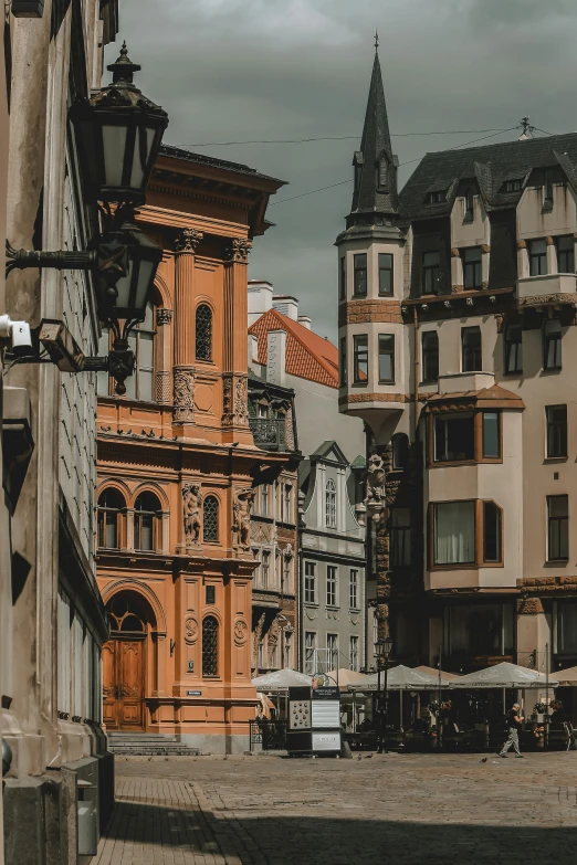 a city street filled with lots of tall buildings, a photo, by Adam Marczyński, pexels contest winner, baroque, storefronts, gray and orange colours, zdzislaw bekinski, brown