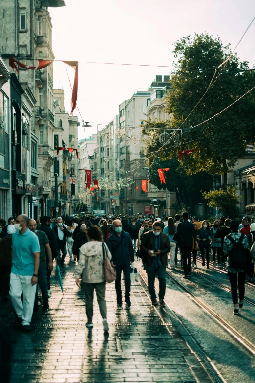 a group of people walking down a street next to tall buildings, istanbul, busy streets filled with people, masks, savannah