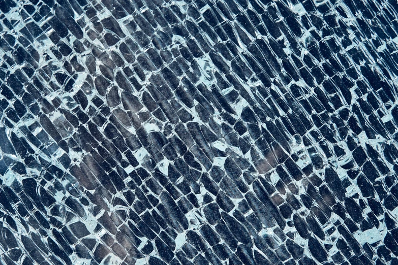 a close up of a cracked glass surface, a mosaic, inspired by Vija Celmins, unsplash, lyrical abstraction, square lines, dark blue tones, aerial photography, ice seracs