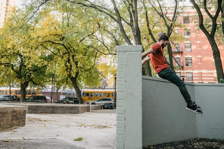 a man riding a skateboard up the side of a cement wall, by William Berra, unsplash, people falling off a playground, minneapolis, high tech concrete bench cube, male calisthenics