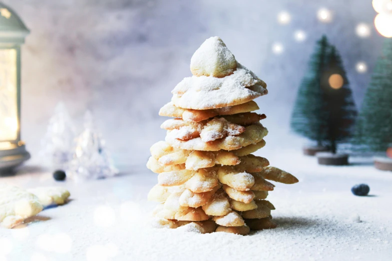 a pile of cookies sitting on top of a table, inspired by Norman Hepple, christmas tree, with snow on its peak, white desert, crispy