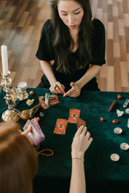 two women sitting at a table playing cards, by Julia Pishtar, trending on pexels, renaissance, displayed on an altar, a witch, flat lay, 15081959 21121991 01012000 4k