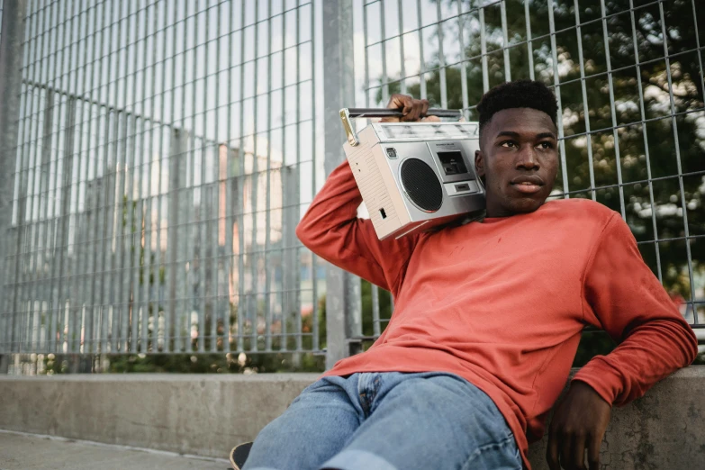 a man laying on the ground with a boombox on his head, trending on pexels, realism, black teenage boy, 15081959 21121991 01012000 4k, classic portrait, rectangle