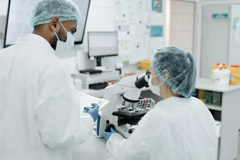 two people in lab coats looking at a microscope, masked doctors, diagnostics, thumbnail, inspect in inventory image