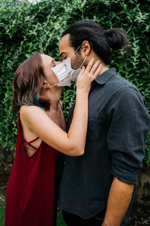 a woman in a red dress kissing a man in a mask, trending on pexels, greens), growth of a couple, dirty, 2 0 5 0 s