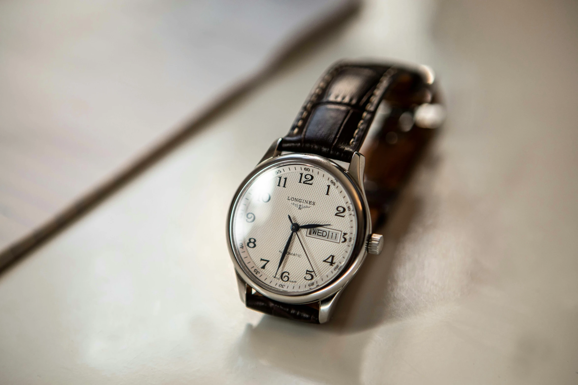 a close up of a wrist watch on a table, inspired by Eugène Brands, fan favorite, traditional medium, thumbnail, white: 0.5