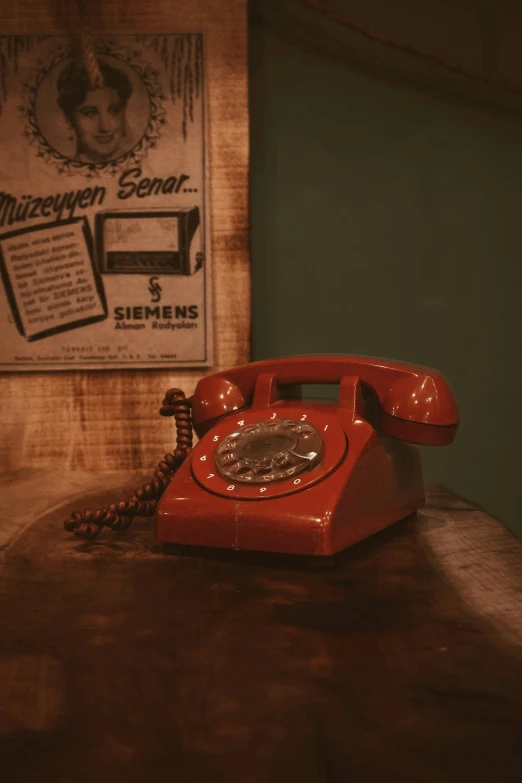 a red telephone sitting on top of a wooden table, vintage aesthetic, brown, still photograph, nostalgic 8k