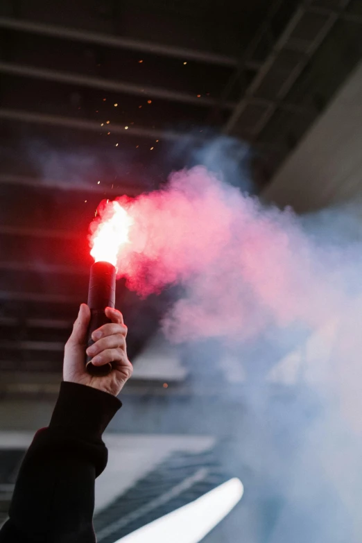 a person holding a red light in their hand, smoke grenades, interrupting the big game, instagram post, wands