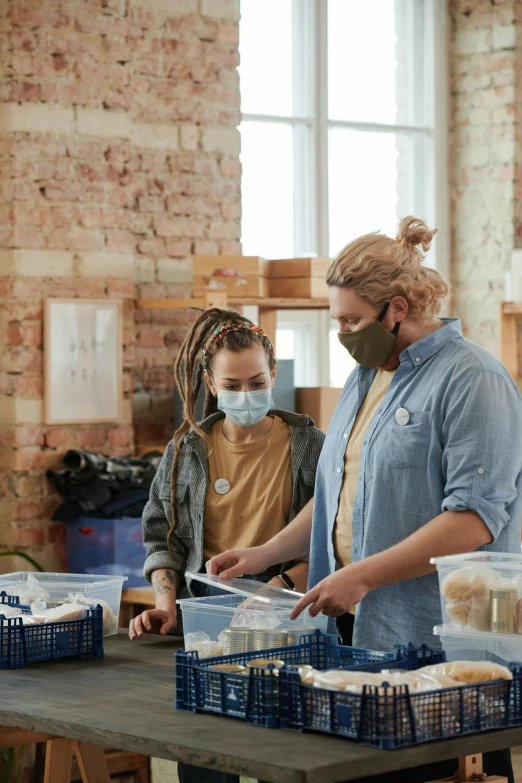 a group of people standing around a table with food, in a warehouse, masks, thumbnail, people shopping