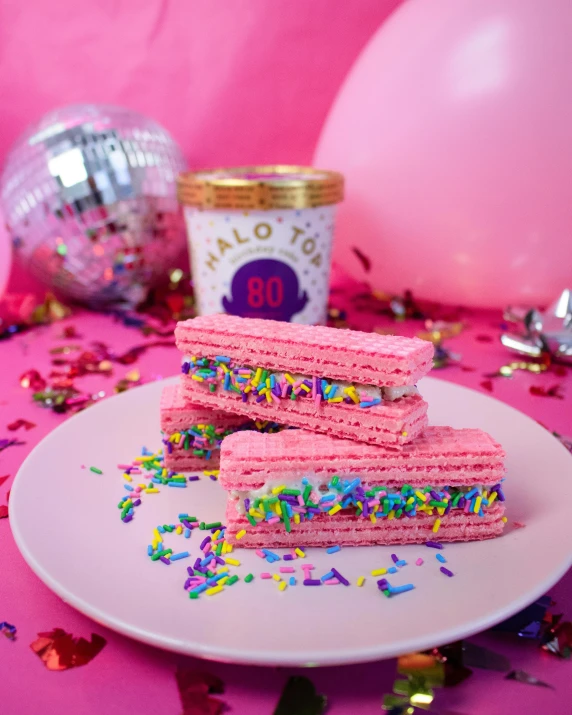 a white plate topped with pink frosting and sprinkles, a hologram, inspired by Peter Alexander Hay, featured on instagram, really long, 4 0 years, snacks, 🍸🍋