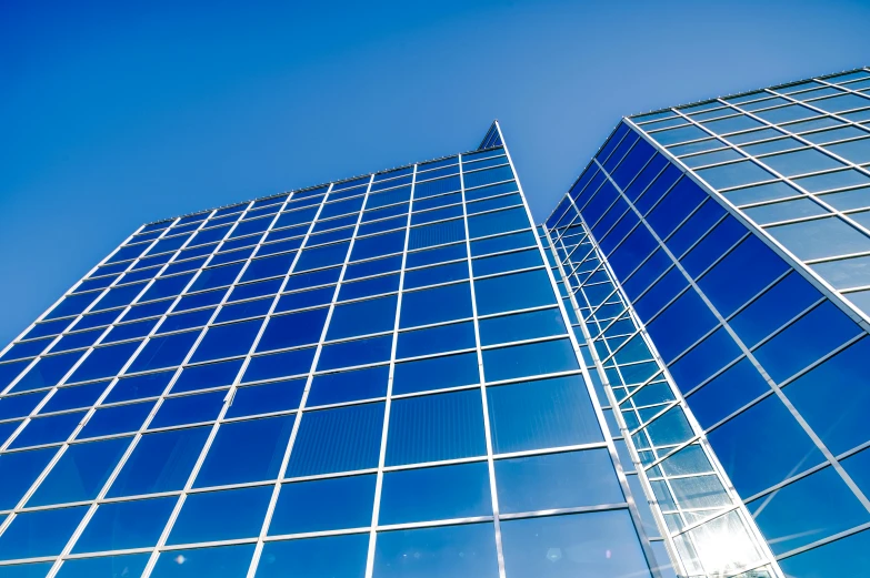 a tall glass building with a blue sky in the background, a picture, by Jan Rustem, unsplash, square lines, corporate memphis, panels, solarised