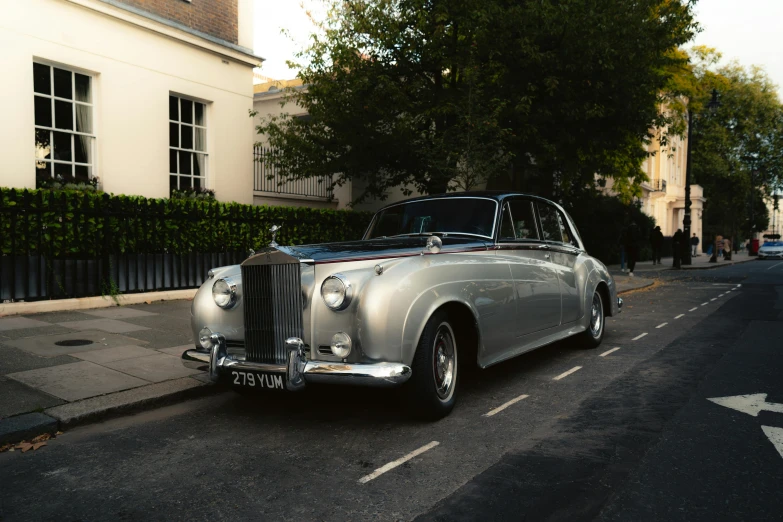 a silver car parked on the side of a road, by Jay Hambidge, unsplash, slim aarons, in london, square, wedding
