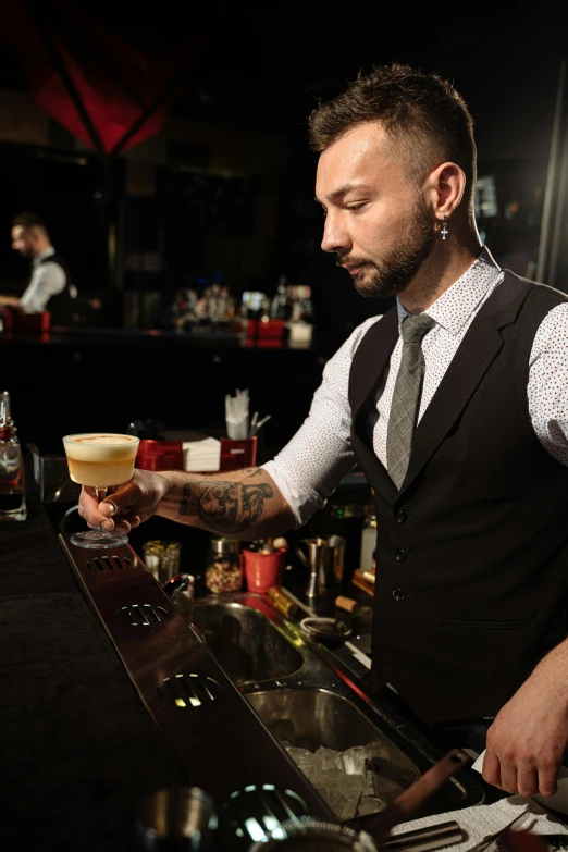 a man standing at a bar pouring a drink, inspired by Carlo Martini, trending on reddit, headshot, lgbtq, mid-20s, thumbnail