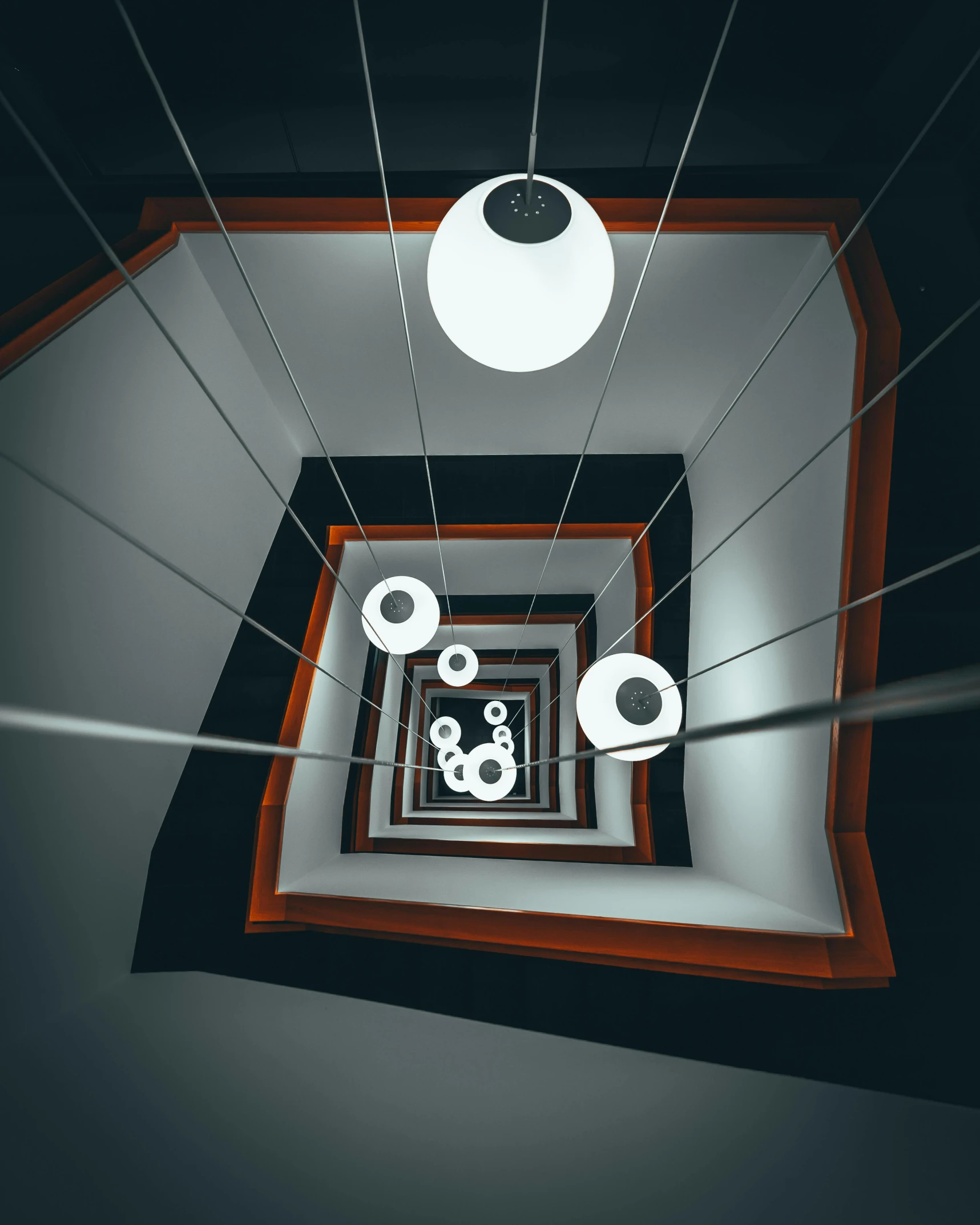 a spiral staircase leading to the top of a building, a 3D render, inspired by MC Escher, pexels contest winner, light and space, dark cables hanging from ceiling, high - angle, square, ilustration