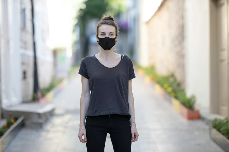 a woman standing on a sidewalk wearing a face mask, pexels contest winner, renaissance, wearing a black t-shirt, dezeen, sydney hanson, sanja stikovic