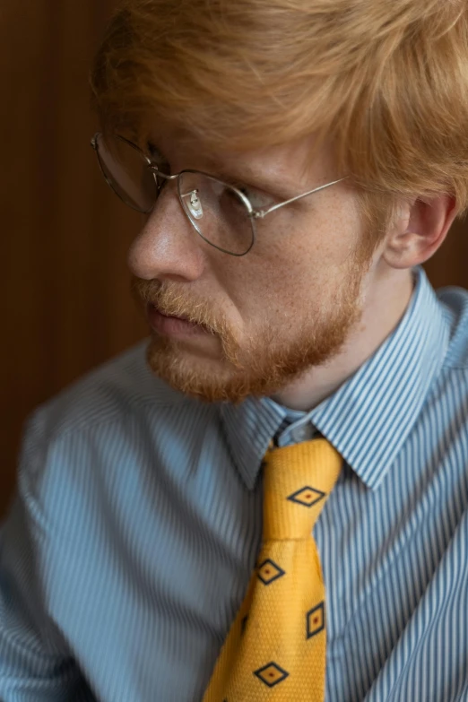 a man in a blue shirt and yellow tie, reddit, photorealism, ginger hair, taken with sony alpha 9, pondering, long tie