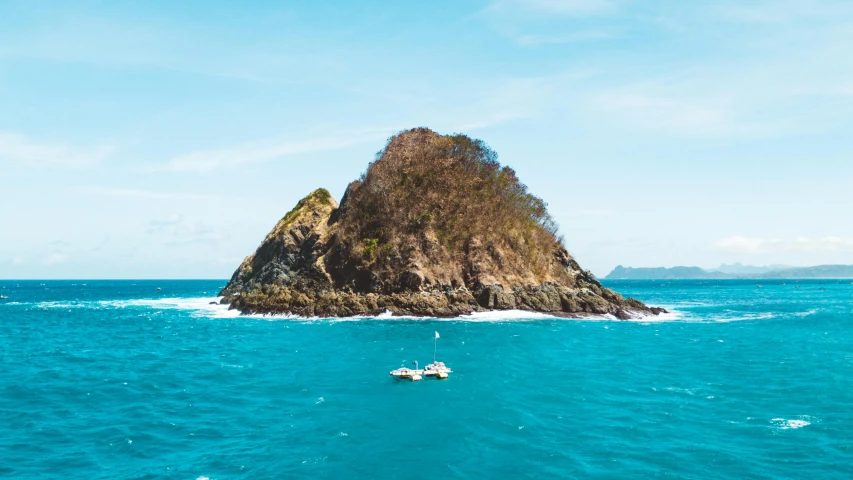 a small boat in the middle of a large body of water, by Drew Tucker, pexels contest winner, flying rocky island, te pae, conde nast traveler photo, slide show