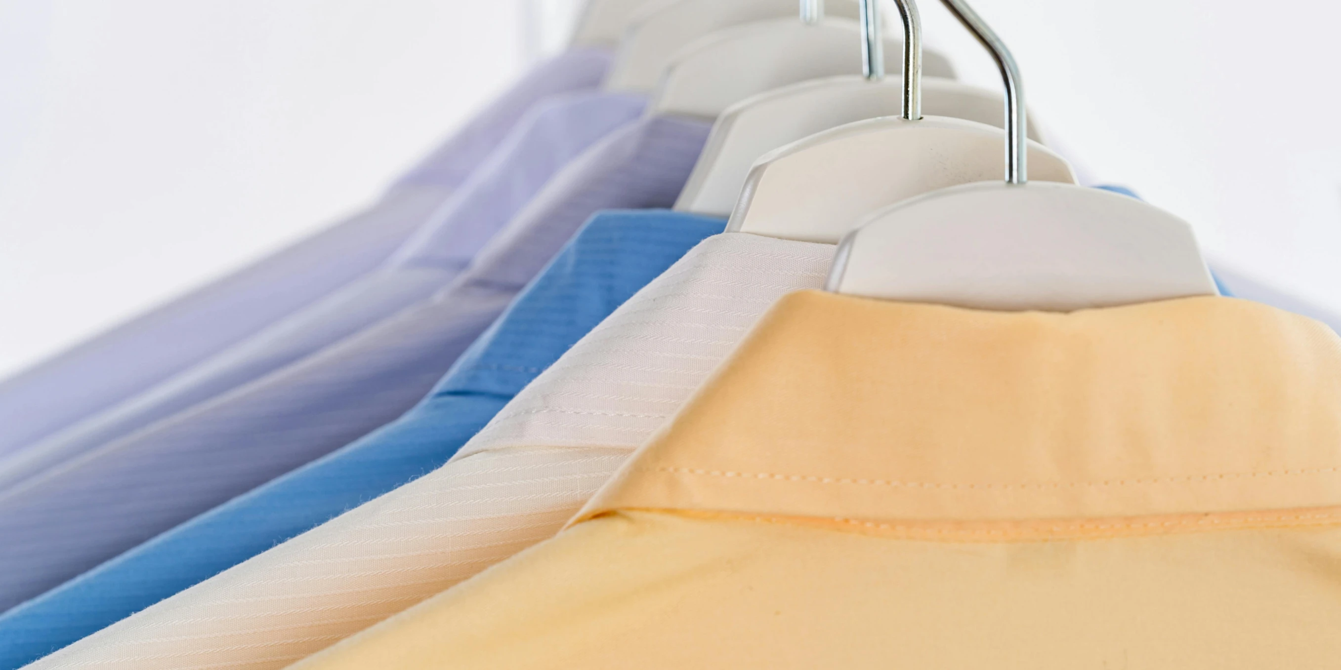 a row of shirts hanging on a clothes rack, by Julian Allen, sterile colours, thumbnail, extra detail, caparisons