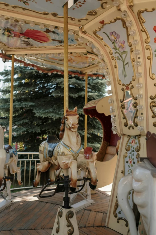 a close up of a carousel with horses on it, by Maksimilijan Vanka, botanical garden, square, grayish, playground
